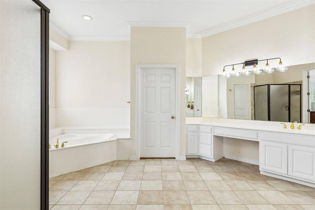 3809 Brookfield Drive, Plano, TX 75025 Primary ensuite offers separate vanities, his-and her closets, glass enclosed shower as well as plentiful storage.