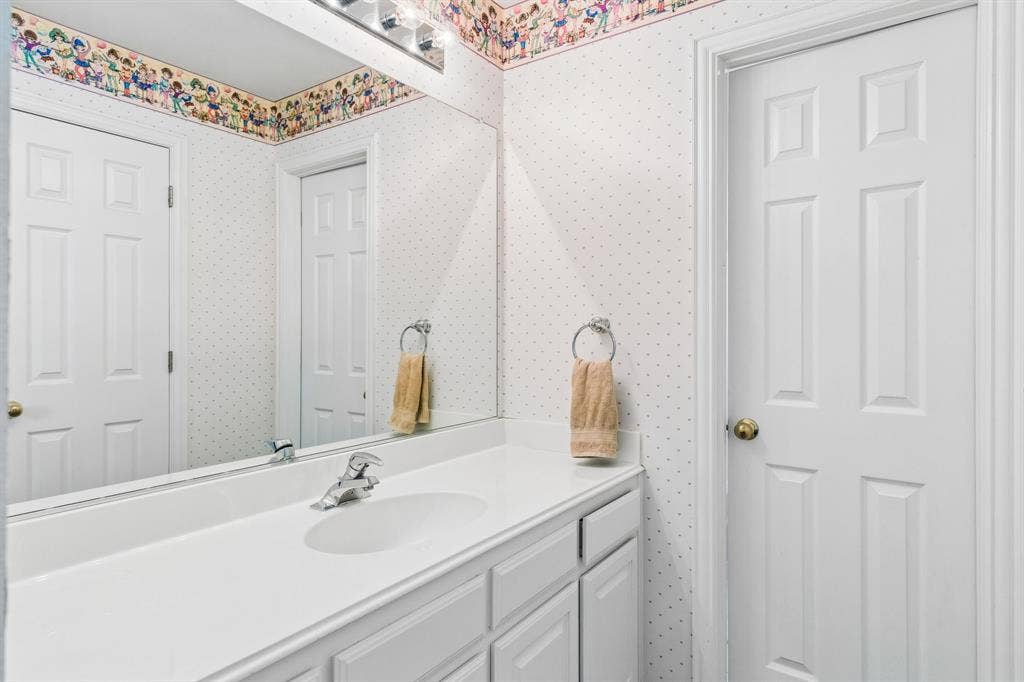 3809 Brookfield Drive, Plano, TX 75025 A full bath on the second level with a tub/shower combination, vanity, and ample storage cabinetry.