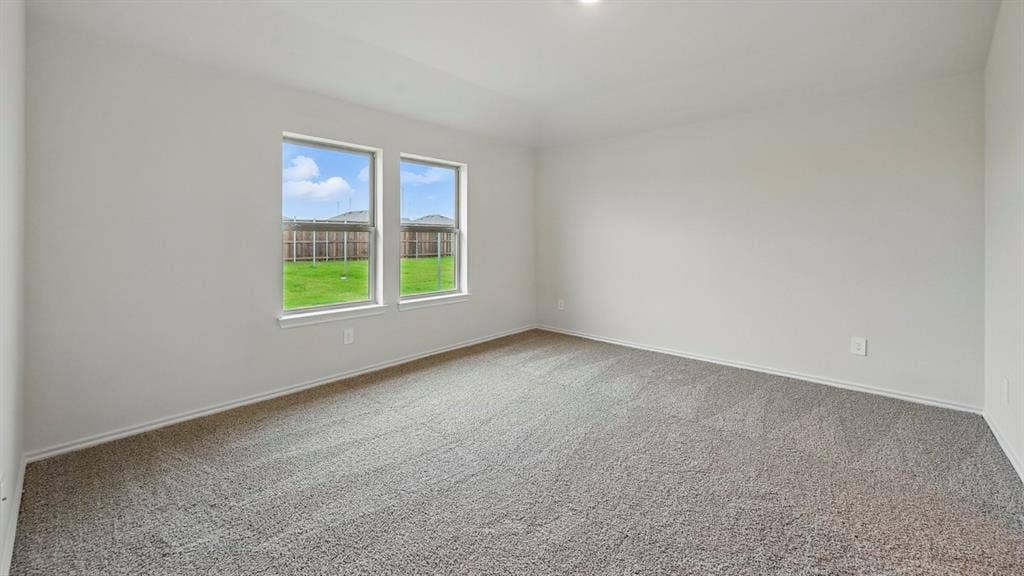 5008 Shumard Drive, Lindale, TX 75771 Spacious room featuring neutral carpeting and light gray wall tones