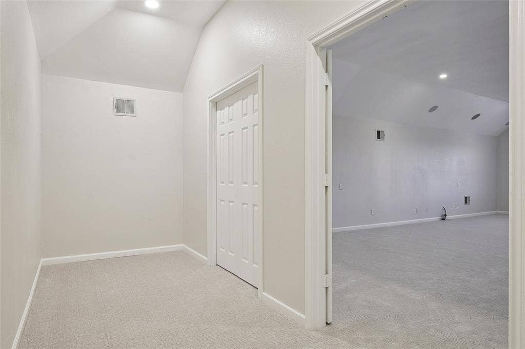 Vaulted ceiling, recessed lighting, carpet flooring, bi-fold closet door, cased doorway
