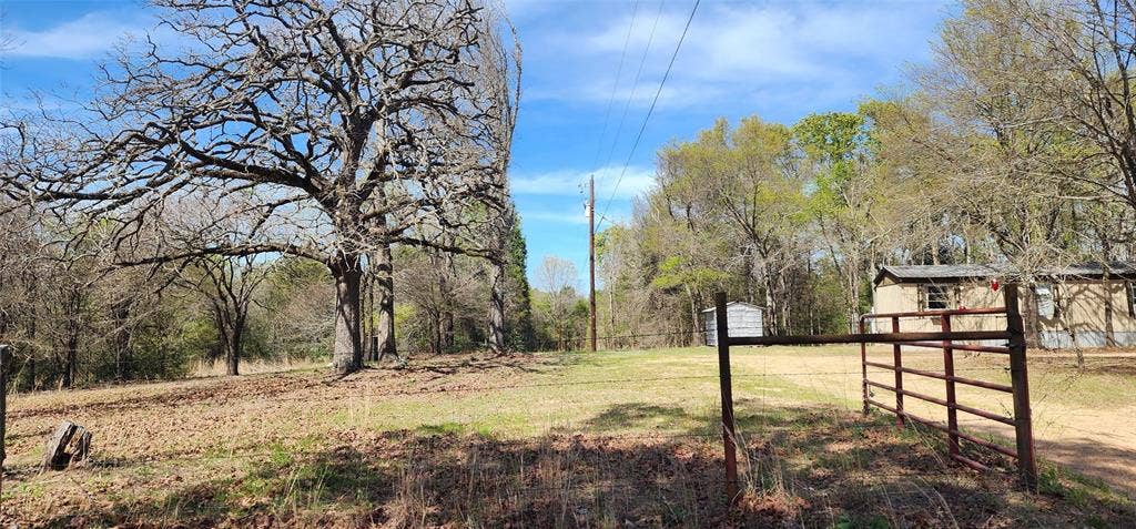14598 County Road 1122, Athens, TX 75751 Expansive open land featuring mature trees and a gated entrance