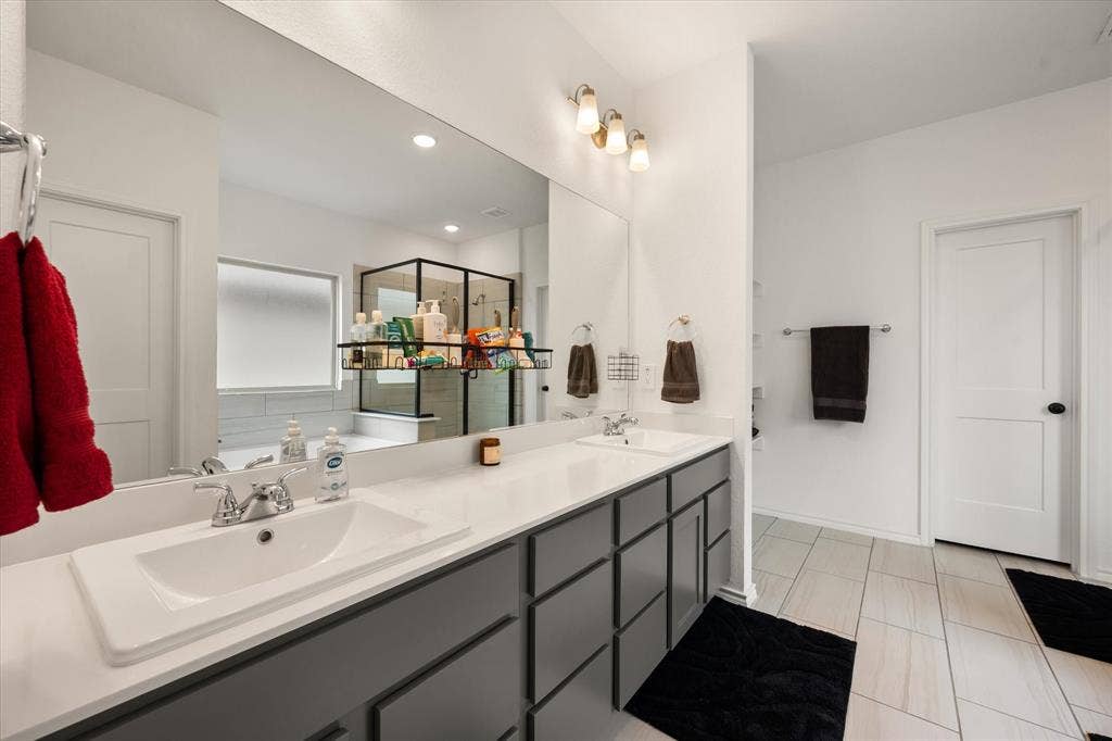 2325 Volans Drive, Haslet, TX 76052 Double vanity with modern, rectangular sinks, chrome fixtures, and grey cabinetry