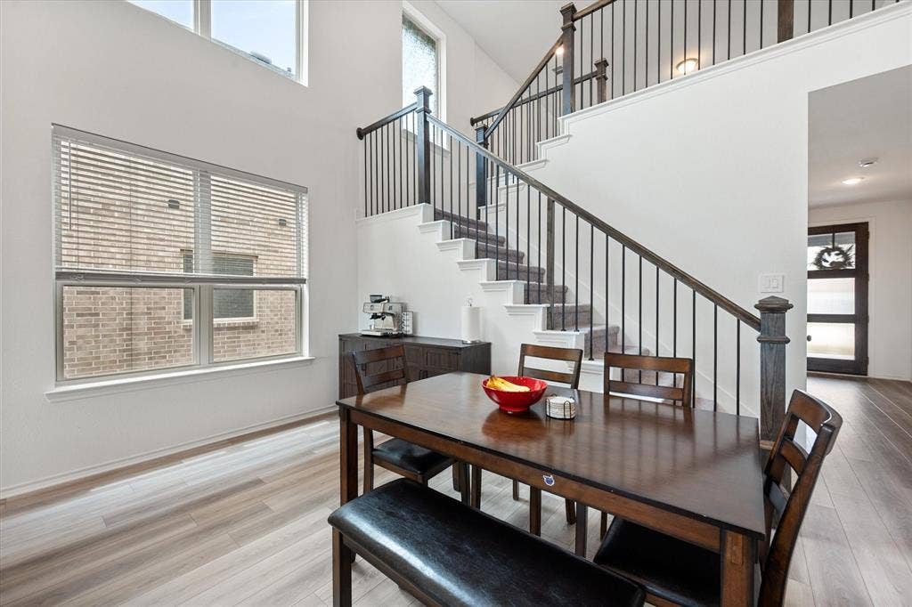 2325 Volans Drive, Haslet, TX 76052 Two-story entryway featuring a wood and wrought iron staircase, wood-finish flooring, and lots of natural light