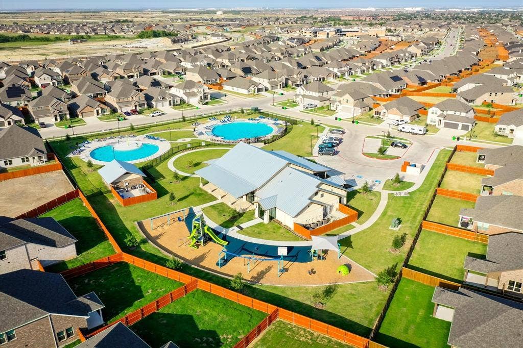 2325 Volans Drive, Haslet, TX 76052 Community amenities featuring two swimming pools, a central clubhouse, and a playground with shade structures