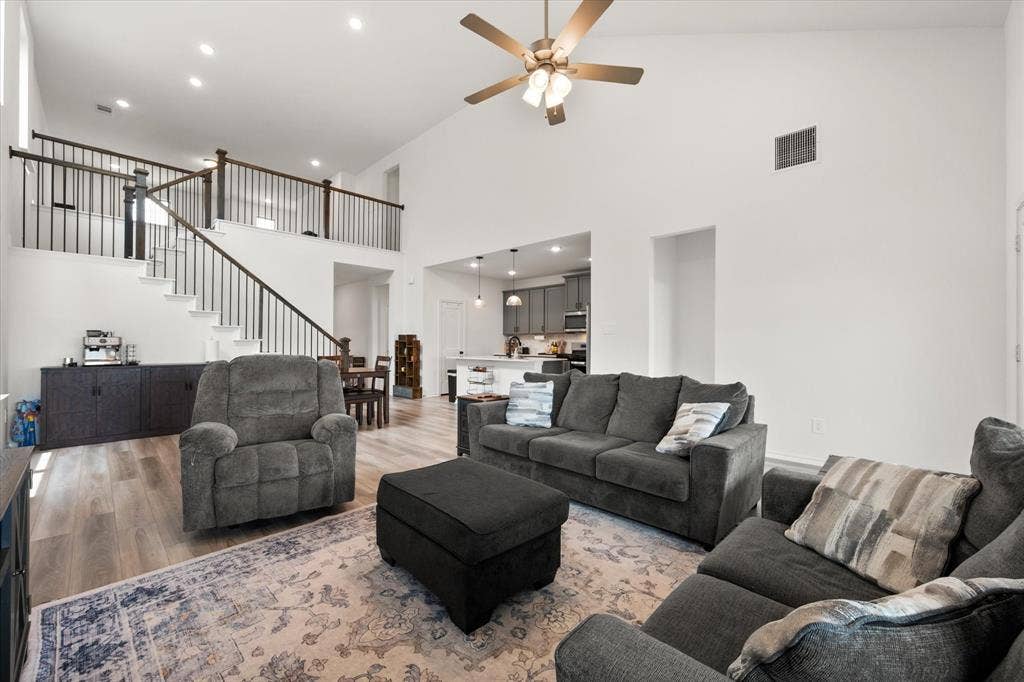 2325 Volans Drive, Haslet, TX 76052 Spacious living area featuring high vaulted ceilings, light wood-finish flooring, and recessed lighting