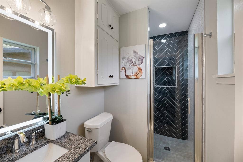 1138 Usher Street, Benbrook, TX 76126 Bathroom with new shower tile, shower door and granite vanity top