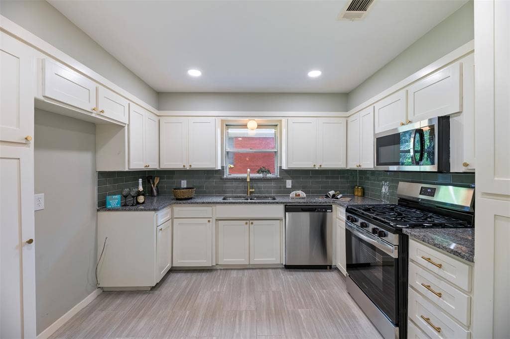 1138 Usher Street, Benbrook, TX 76126 Kitchen with new granite counters, backsplash, sink, and faucet