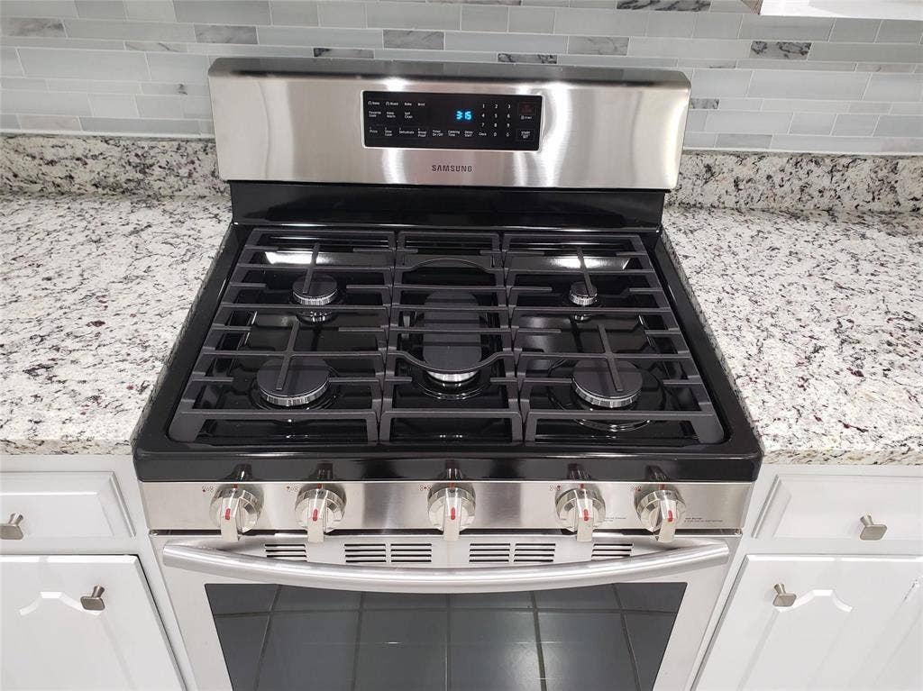 4355 Harvest Hill Road, Dallas, TX 75244 Gas stovetop with a convection oven.