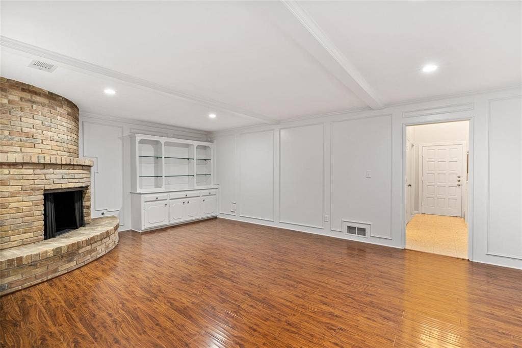 4355 Harvest Hill Road, Dallas, TX 75244 Large living room with built-in storage, gleaming floors and neutral paint.