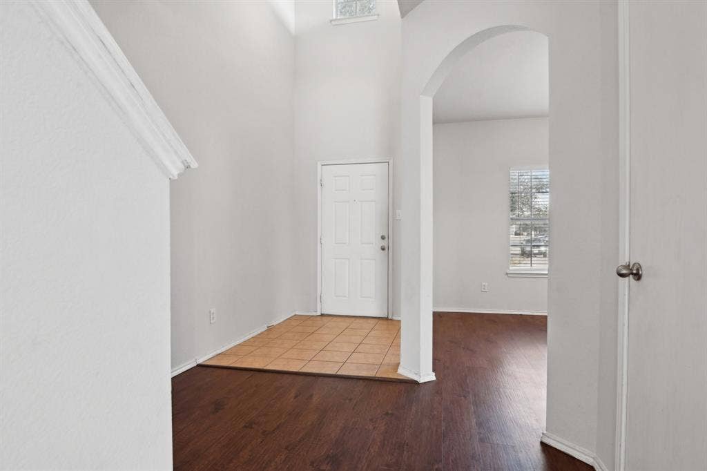 3019 Appaloosa Drive, Dallas, TX 75237 Foyer entrance with hardwood / wood-style flooring and a towering ceiling
