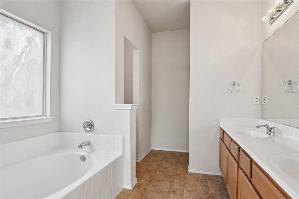 3019 Appaloosa Drive, Dallas, TX 75237 Bathroom with vanity and tiled bath, and separate tub