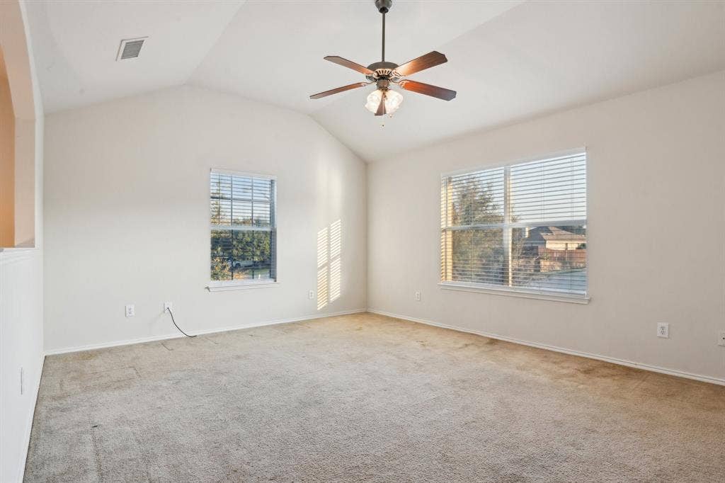 3019 Appaloosa Drive, Dallas, TX 75237 room featuring vaulted ceiling, light carpet, and ceiling fan