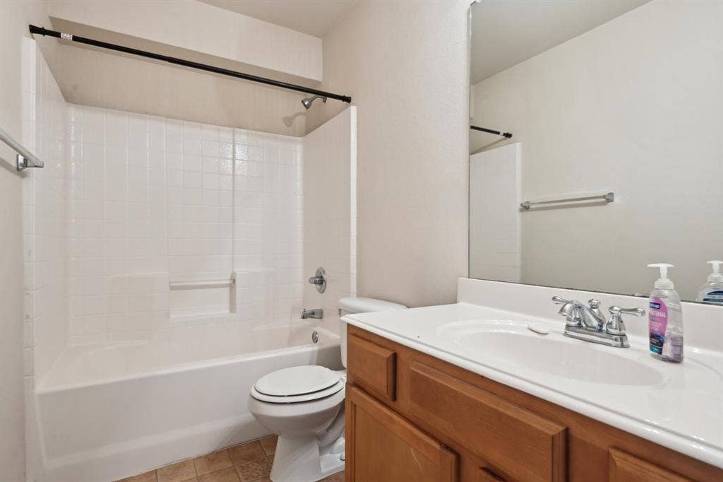 3019 Appaloosa Drive, Dallas, TX 75237 Full bathroom with vanity, toilet, tile patterned flooring, and shower / bathing tub combination