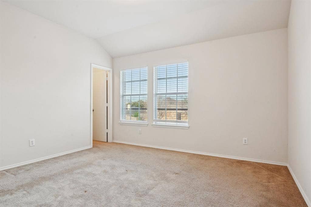 3019 Appaloosa Drive, Dallas, TX 75237 Carpeted spare room featuring lofted ceiling