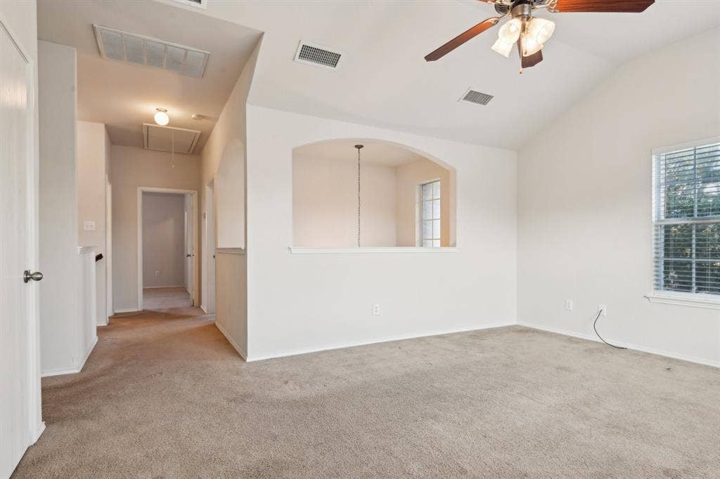 3019 Appaloosa Drive, Dallas, TX 75237 Carpeted spare room featuring lofted ceiling and ceiling fan