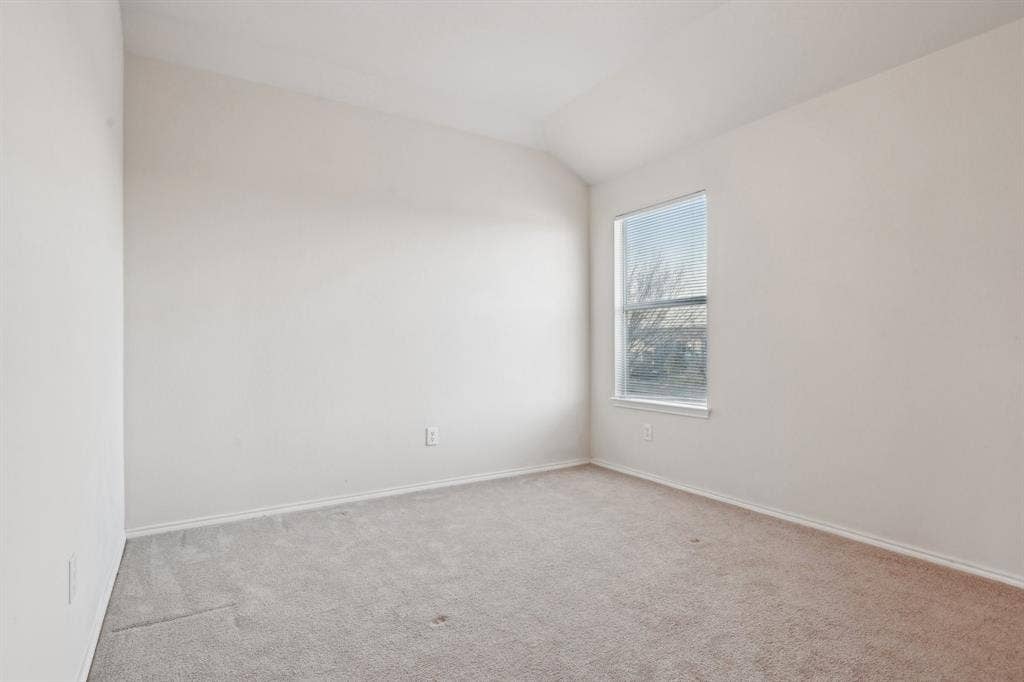 3019 Appaloosa Drive, Dallas, TX 75237 Carpeted empty room featuring lofted ceiling