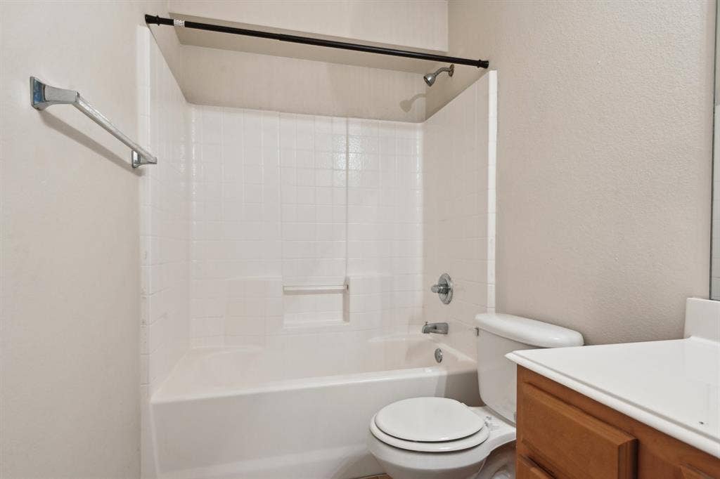 3019 Appaloosa Drive, Dallas, TX 75237 Full bathroom featuring shower / bath combination, vanity, and toilet