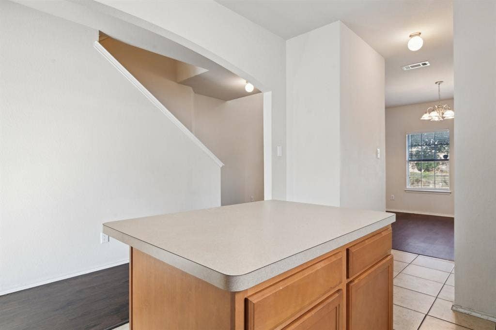 3019 Appaloosa Drive, Dallas, TX 75237 Kitchen with a center island and light tile patterned floors