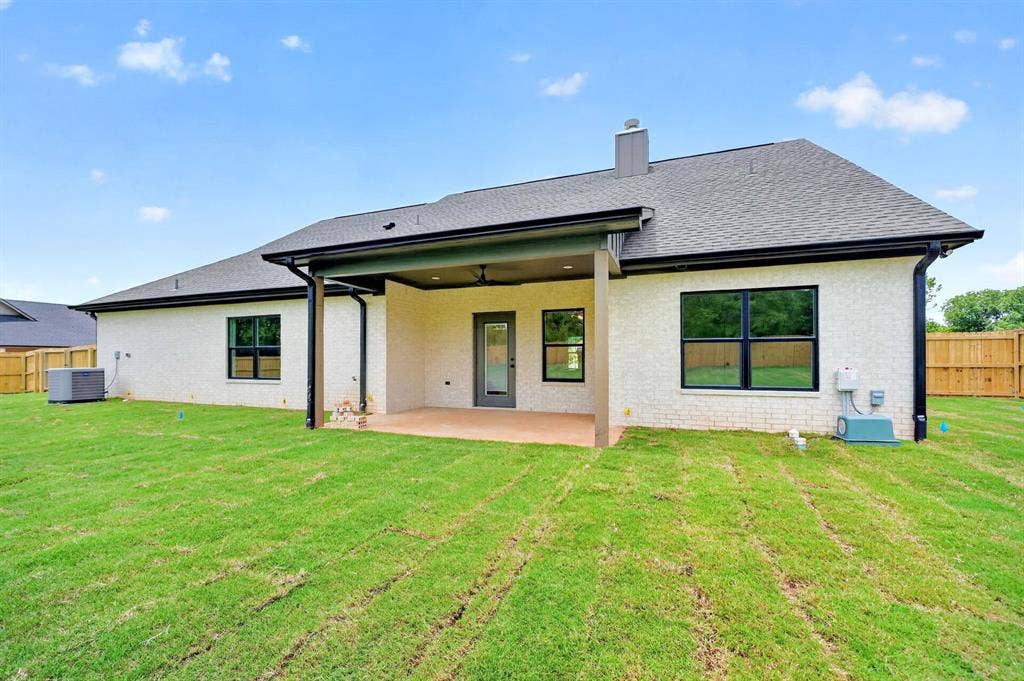 301 Grace Lane, Athens, TX 75751 Spacious backyard with a covered patio, featuring a ceiling fan and recessed lighting
