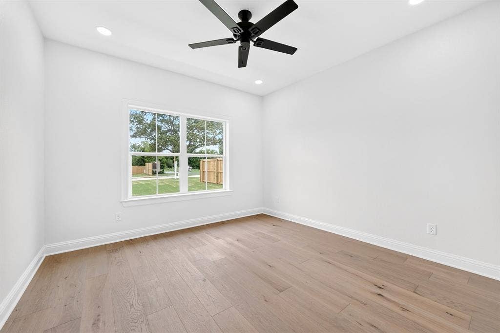 301 Grace Lane, Athens, TX 75751 Room featuring wood-finish flooring, a large window, recessed lighting, a ceiling fan, and white baseboards