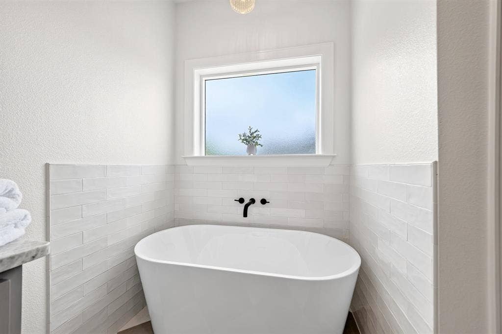 301 Grace Lane, Athens, TX 75751 Freestanding soaking tub with matte black wall-mounted fixtures