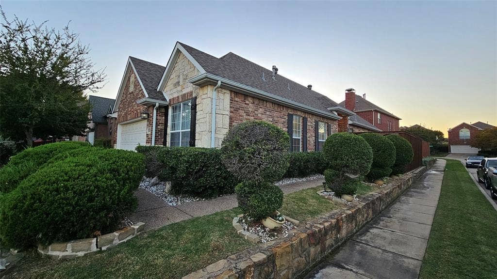 Brick and stone exterior featuring gabled rooflines