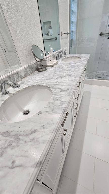 Dual vanity with integrated sinks, marble countertop, and chrome faucets