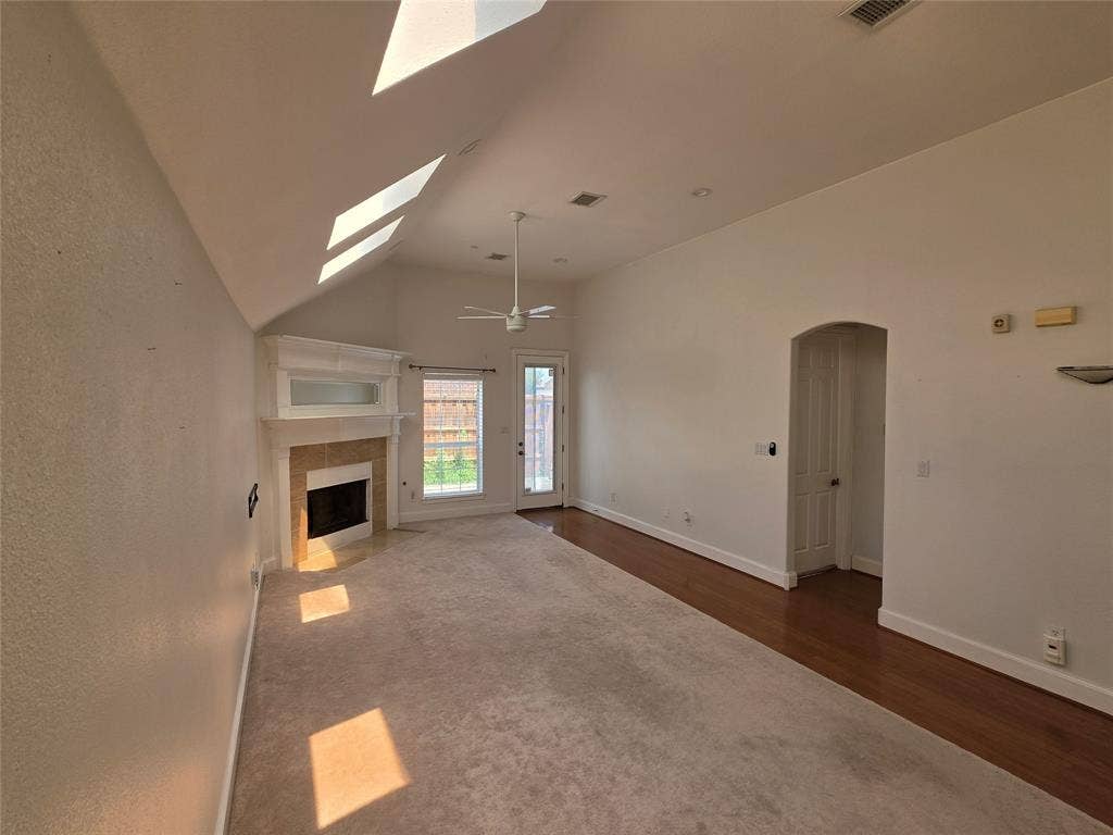 Living area with vaulted ceilings and a white ceiling fan