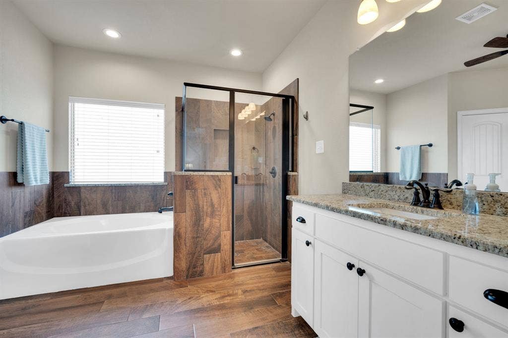 Primary bathroom with separate vanities.