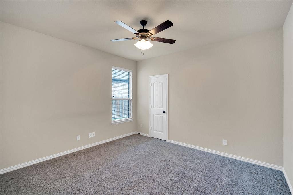 One of two first floor secondary bedrooms with a decent size closet.