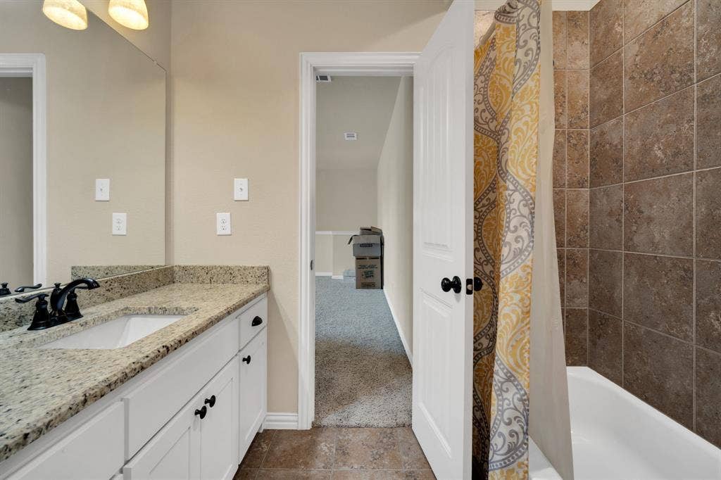 Second floor full bathroom. Nice size vanity with granite counter tops. Shower tub combo.