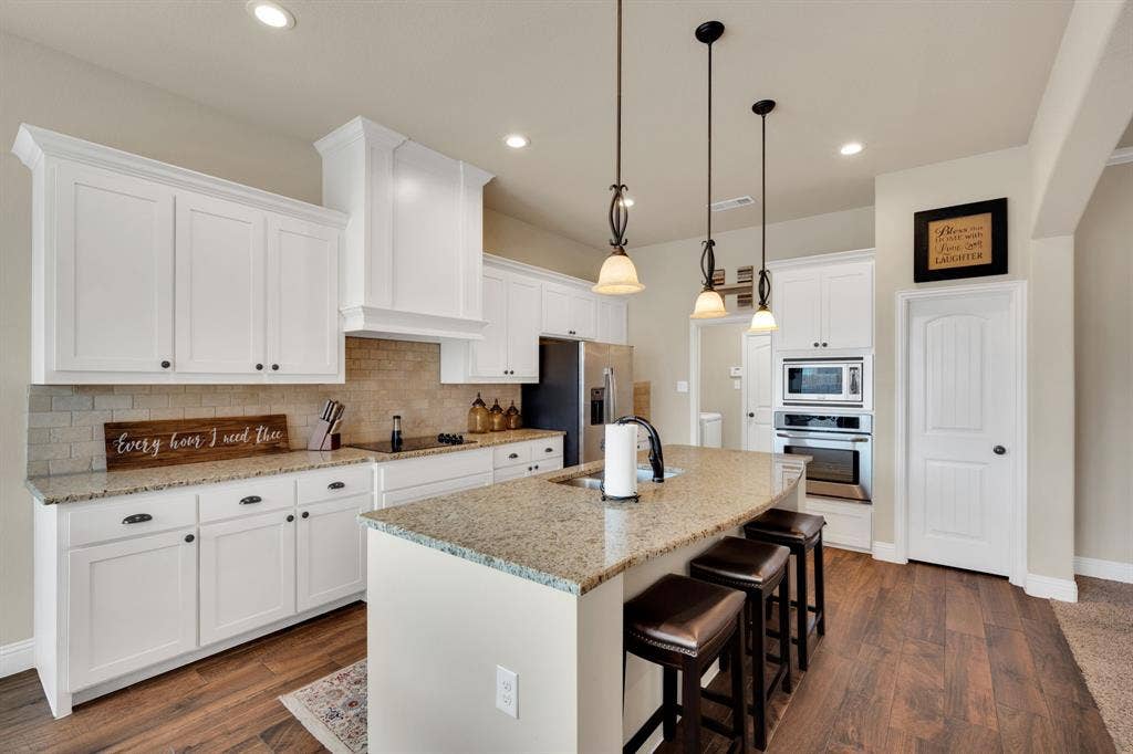 For those who love separate pantry space this is your kitchen! The door to the right of the oven is a large walk in pantry with loads of storage and pantry shelves!