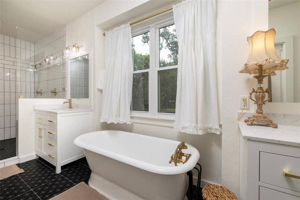 Freestanding soaking tub with gold-tone fixtures