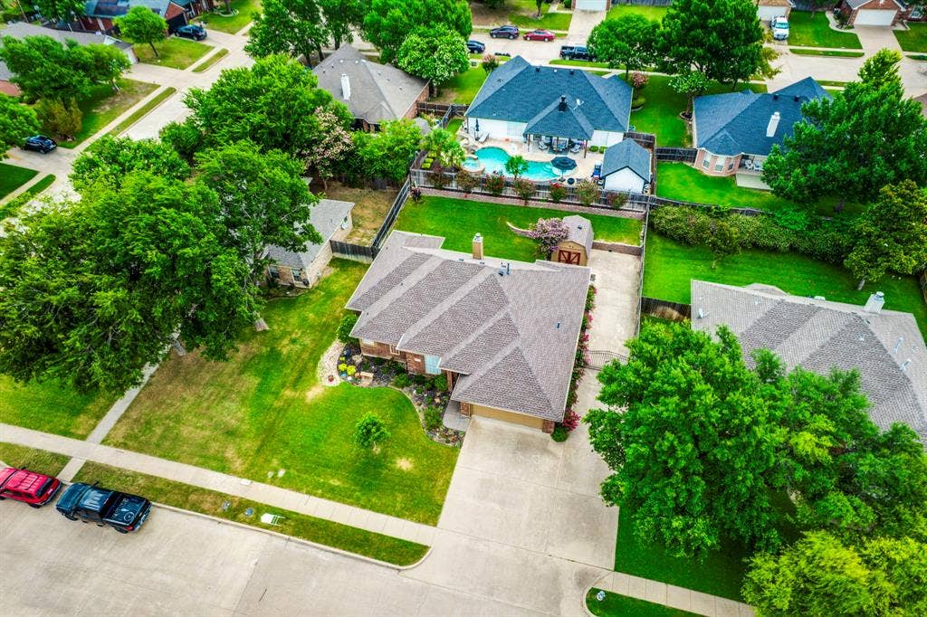 Residential property featuring a shingled roof and an attached garage