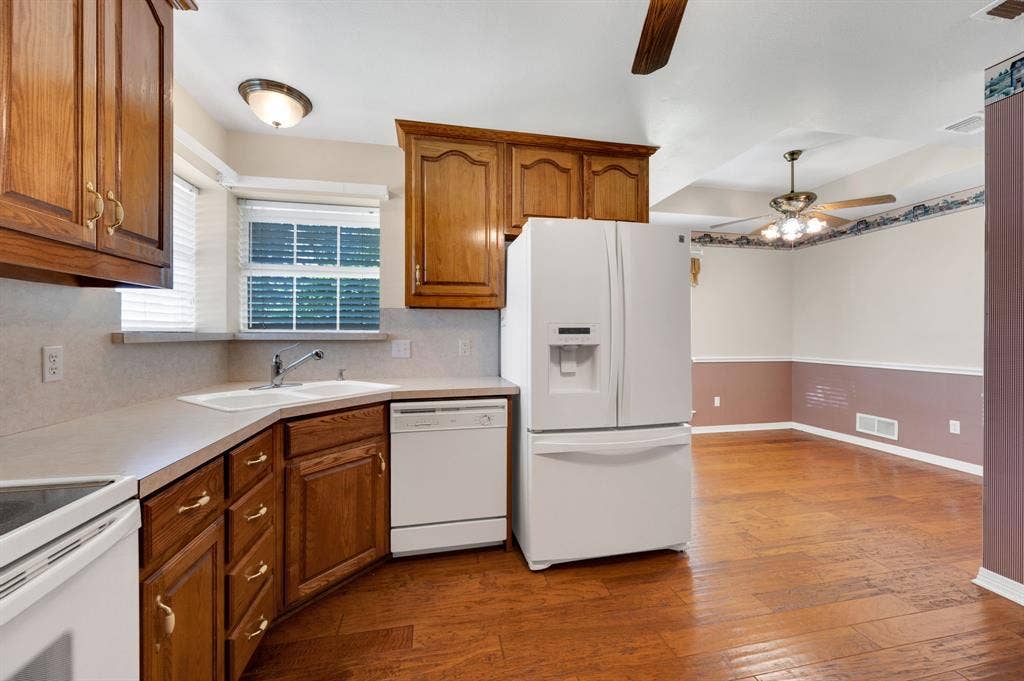 Kitchen and dining area featuring wood-finish flooring