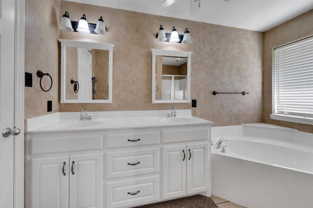 Double vanity with white cabinetry and integrated sinks