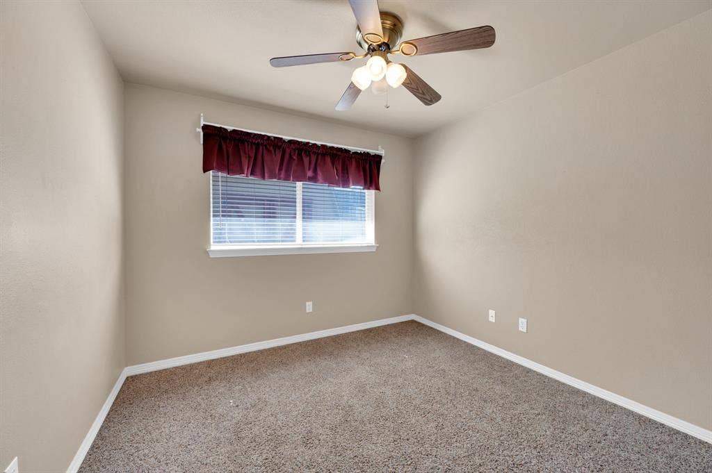 Neutral-toned walls and plush, speckled carpeting define this room