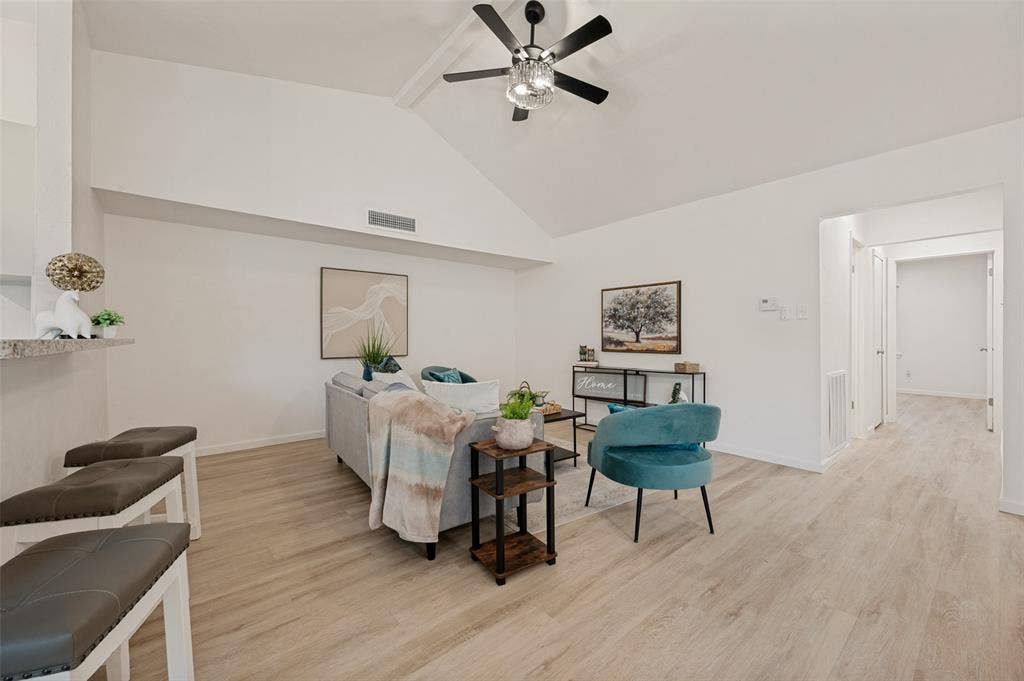 412 Pogue Street, Cedar Hill, TX 75104 Living area featuring a vaulted ceiling and wood-finish flooring