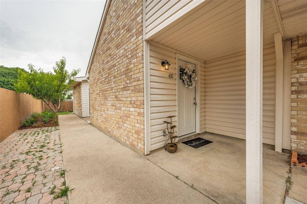 412 Pogue Street, Cedar Hill, TX 75104 Covered entry with beige siding and a light brick facade