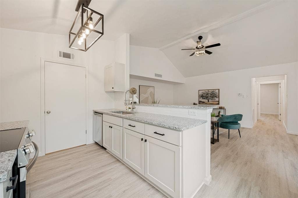 412 Pogue Street, Cedar Hill, TX 75104 Kitchen featuring white shaker cabinetry, stainless steel appliances, granite-style countertops, and wood-finish flooring