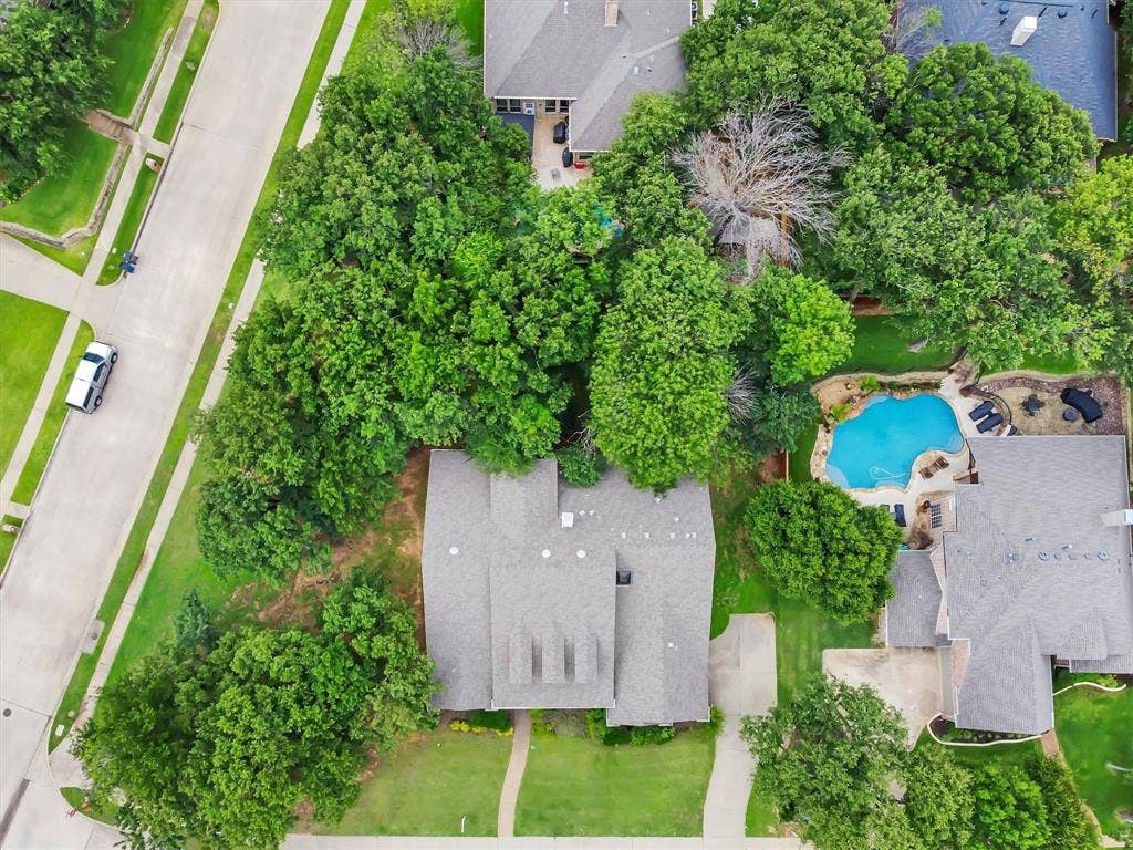 Aerial perspective showcasing the over sized corner lot and property's expansive lot with mature trees