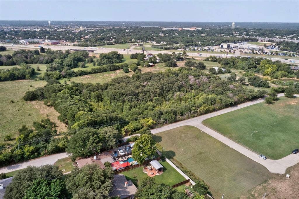 Expansive undeveloped land parcel with significant tree coverage and clearings
