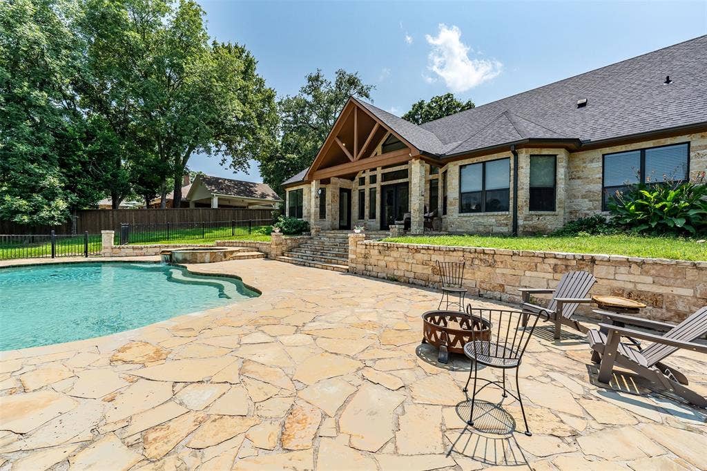 6414 Dorsey Drive, Athens, TX 75752 Expansive flagstone patio surrounding a freeform swimming pool with an integrated spa