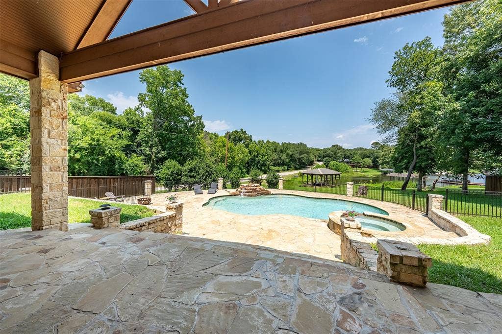 6414 Dorsey Drive, Athens, TX 75752 Covered outdoor patio with flagstone flooring, stone columns, and a wood-beam ceiling