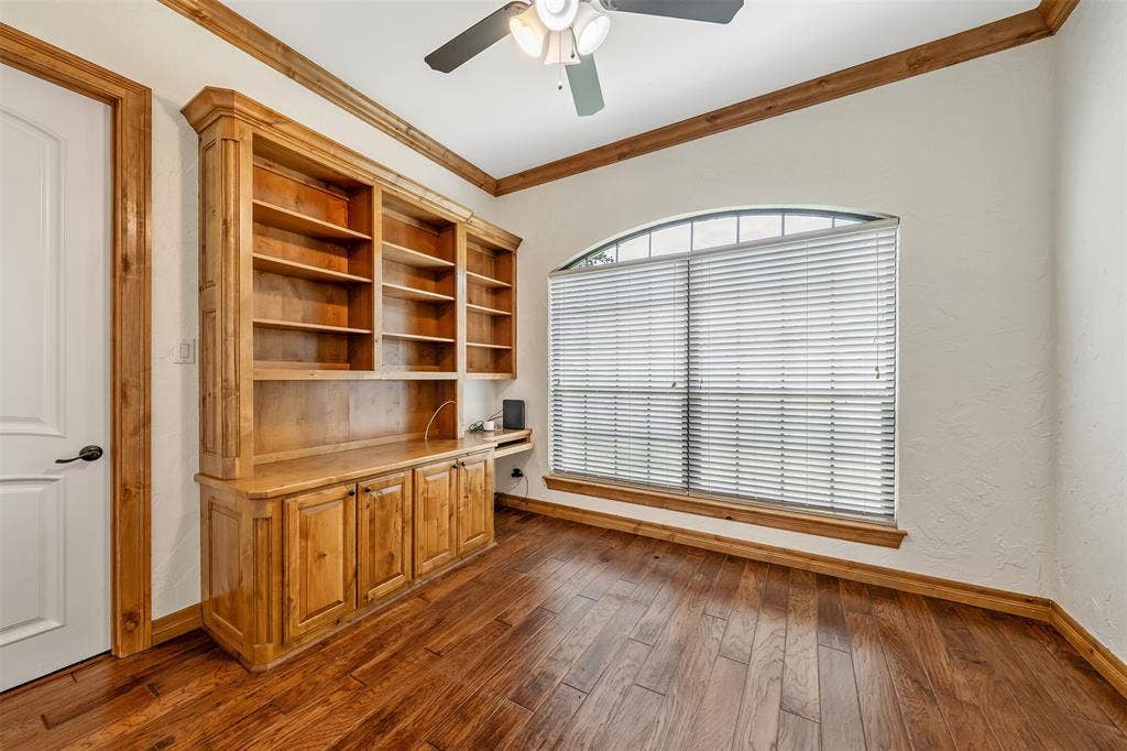 6414 Dorsey Drive, Athens, TX 75752 Built-in wood cabinetry featuring open shelving and closed storage, complemented by rich wood-finish flooring