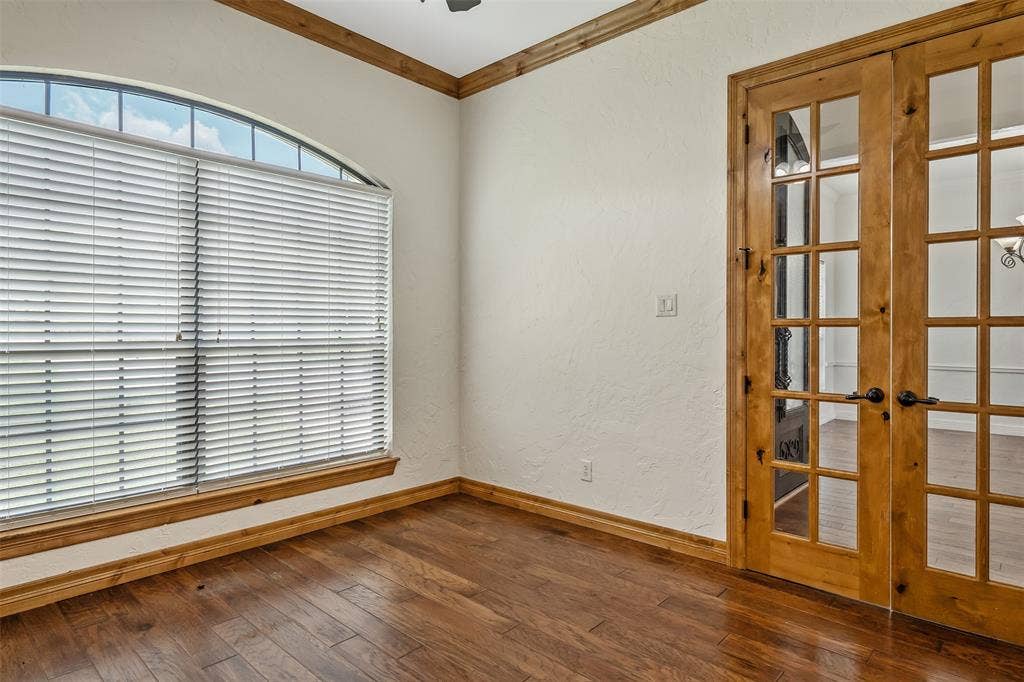 6414 Dorsey Drive, Athens, TX 75752 Arch-top window with blinds, wood-finish flooring, and natural wood French doors