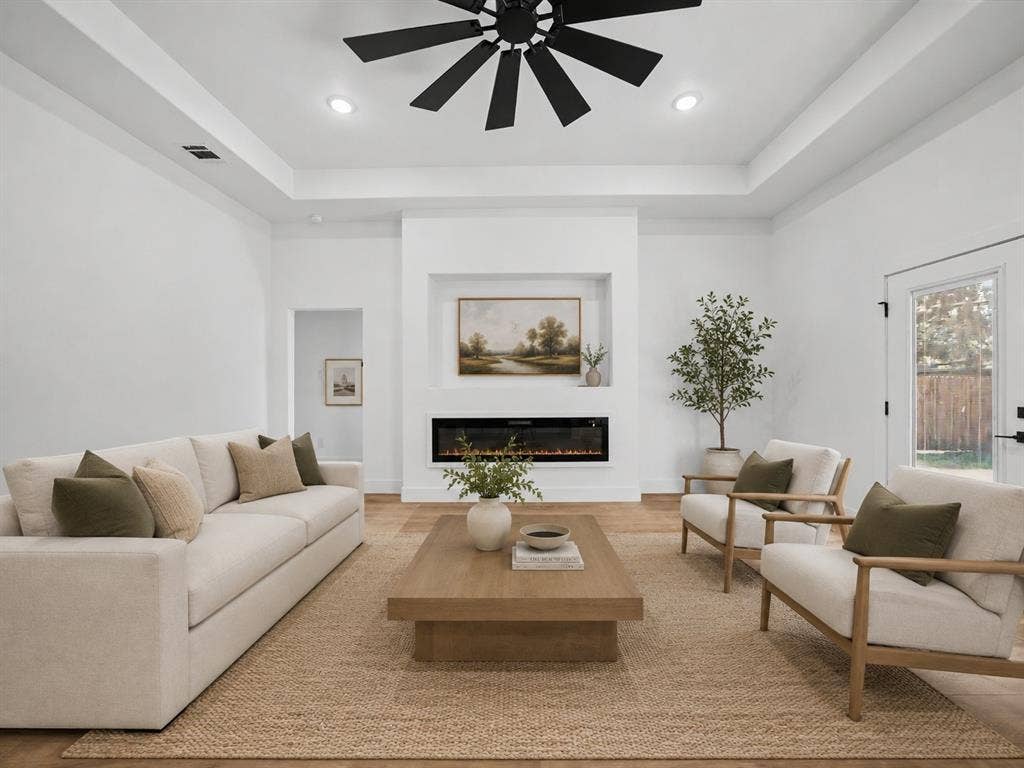 113 Dennis Drive, Azle, TX 76020 Spacious living area featuring high tray ceilings, recessed lighting, and wood-finish flooring