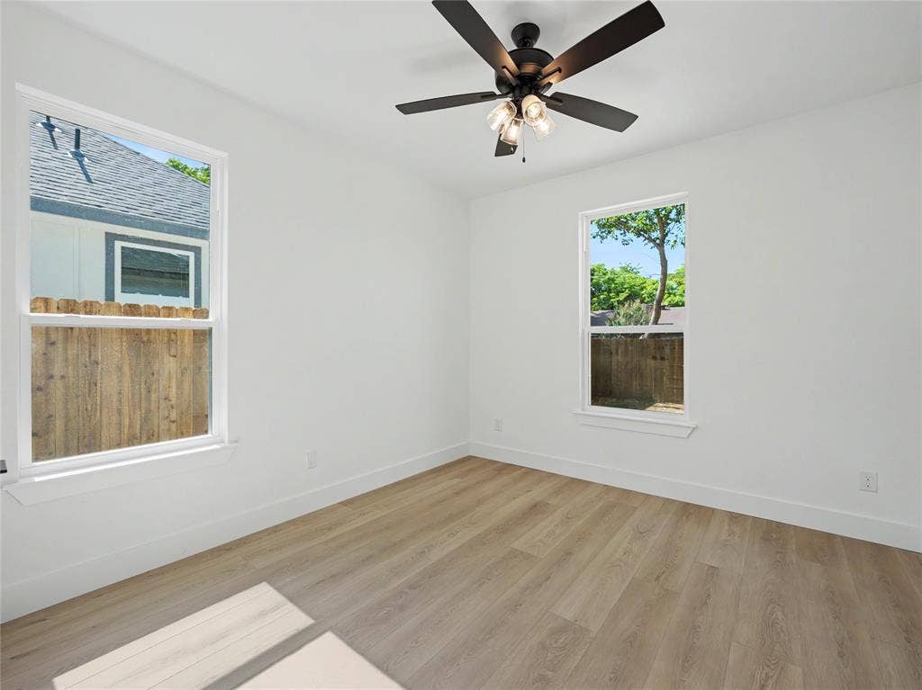 113 Dennis Drive, Azle, TX 76020 Room featuring wood-finish flooring, white walls, and a ceiling fan with light fixture