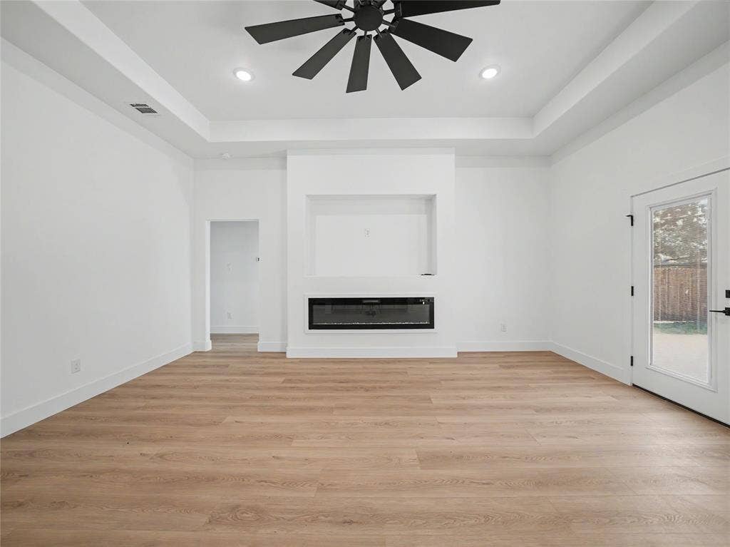 113 Dennis Drive, Azle, TX 76020 Spacious interior with wood-finish flooring, a built-in electric fireplace, recessed lighting, and a contemporary ceiling fan