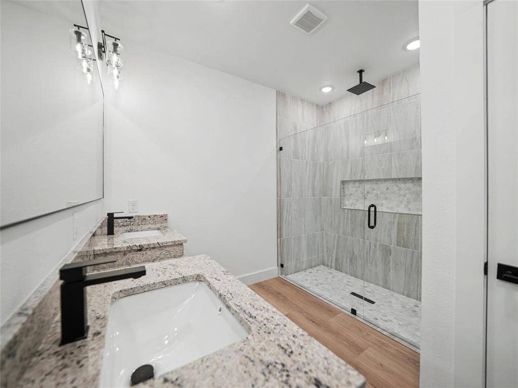 113 Dennis Drive, Azle, TX 76020 Spacious bathroom featuring a dual vanity with granite countertops, undermount sinks, and matte black fixtures